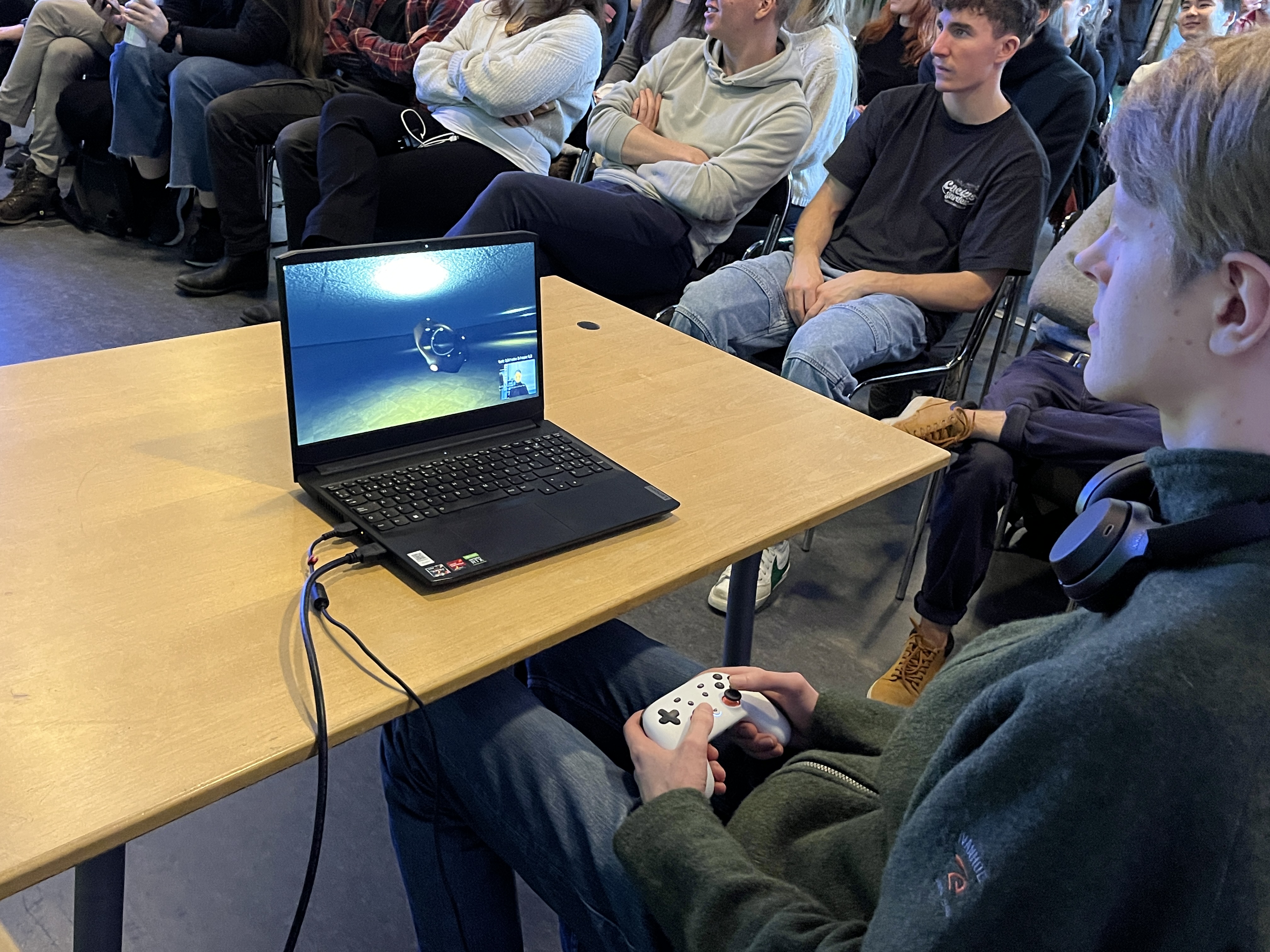 User playing the game with an audience watching on a big screen